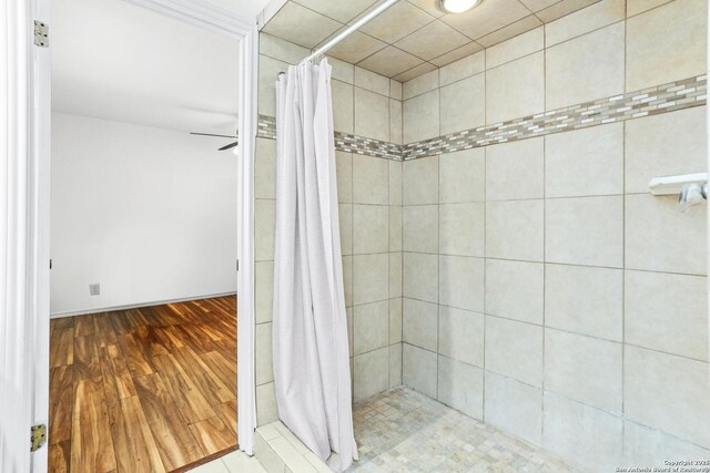 8633 Datapoint Unit 236, San Antonio, TX 78229 - full bath with a tile shower, wood finished floors, and baseboards