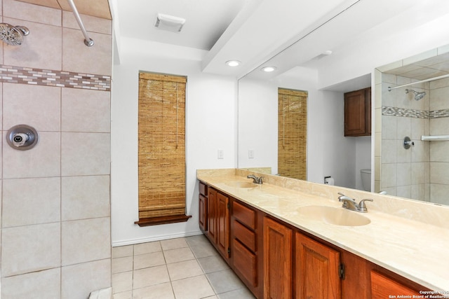 8633 Datapoint Unit 236, San Antonio, TX 78229 - full bathroom featuring double vanity, tiled shower, tile patterned flooring, toilet, and recessed lighting