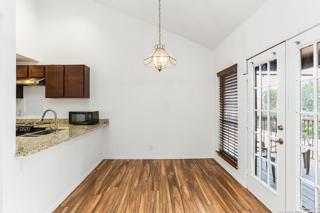 8633 Datapoint Unit 236, San Antonio, TX 78229 - unfurnished dining area with a sink, dark wood finished floors, a chandelier, baseboards, and high vaulted ceiling