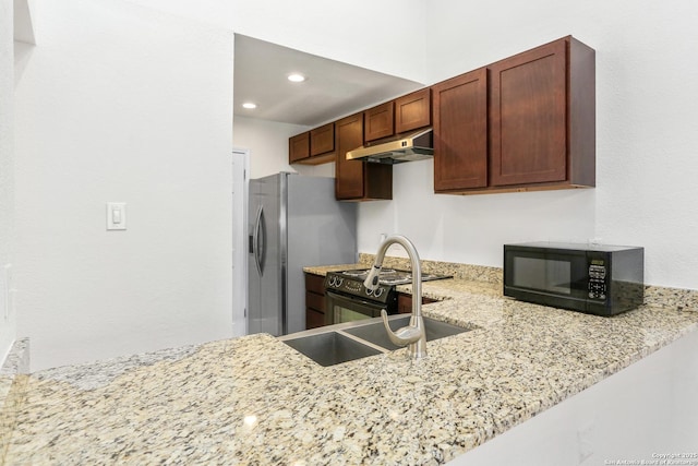 8633 Datapoint Unit 236, San Antonio, TX 78229 - kitchen featuring black microwave, a sink, under cabinet range hood, light stone counters, and recessed lighting
