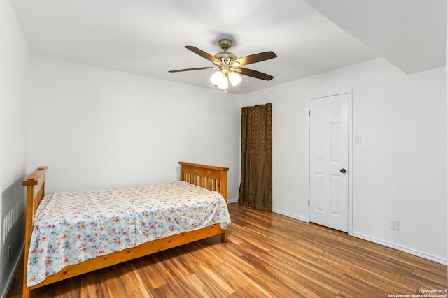 8633 Datapoint Unit 236, San Antonio, TX 78229 - bedroom with wood finished floors, baseboards, and a ceiling fan