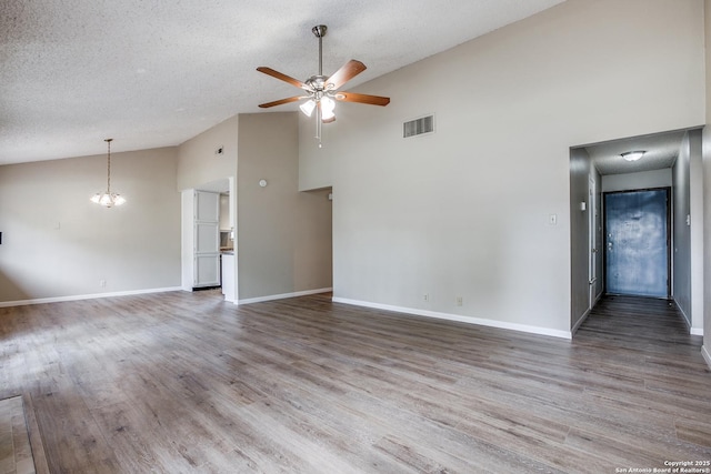 3030 Heidi St, San Antonio, TX 78247 - unfurnished living room with ceiling fan, high vaulted ceiling, a textured ceiling, wood finished floors, and baseboards