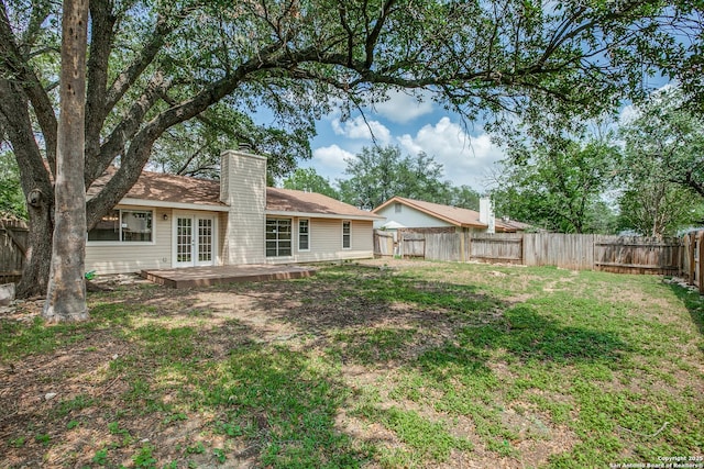 3030 Heidi St, San Antonio, TX 78247 - back of property featuring french doors and a chimney