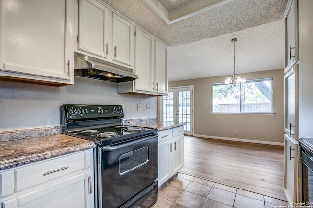 3030 Heidi St, San Antonio, TX 78247 - kitchen featuring black range with electric stovetop, under cabinet range hood, healthy amount of natural light, a textured ceiling, and white cabinetry
