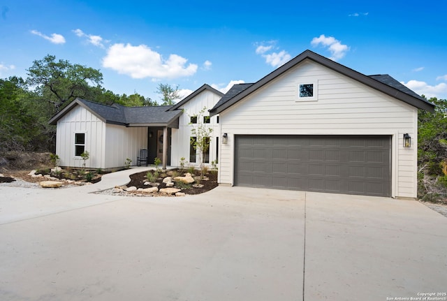 604 Compass Rose, Canyon Lake, TX 78133 - modern farmhouse featuring concrete driveway, board and batten siding, a garage, and roof with shingles