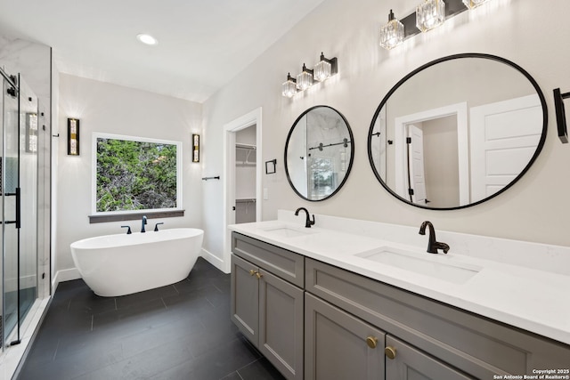 604 Compass Rose, Canyon Lake, TX 78133 - full bath featuring a stall shower, double vanity, a freestanding tub, baseboards, and recessed lighting