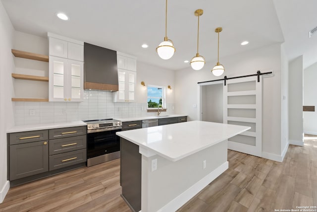 604 Compass Rose, Canyon Lake, TX 78133 - kitchen with stainless steel appliances, a barn door, open shelves, a sink, and premium range hood