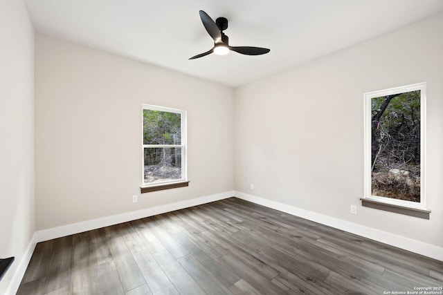 604 Compass Rose, Canyon Lake, TX 78133 - empty room with plenty of natural light, dark wood finished floors, ceiling fan, and baseboards