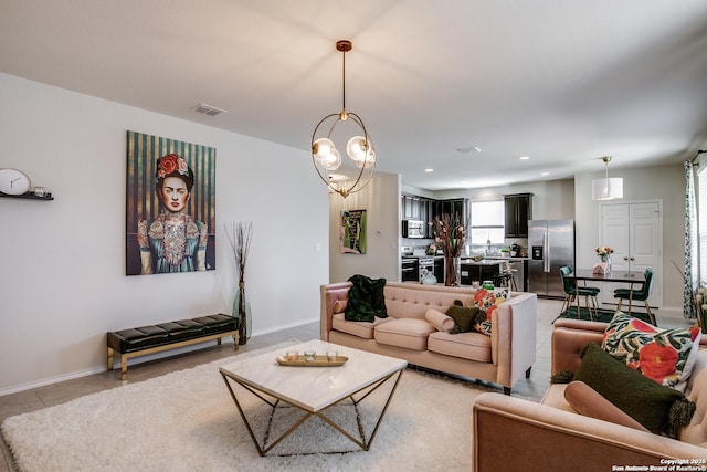 9910 Cowboy Ln, San Antonio, TX 78254 - living area featuring baseboards, recessed lighting, light tile patterned floors, and a chandelier