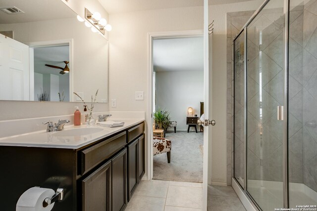 9910 Cowboy Ln, San Antonio, TX 78254 - ensuite bathroom featuring double vanity, tile patterned flooring, a stall shower, and ceiling fan