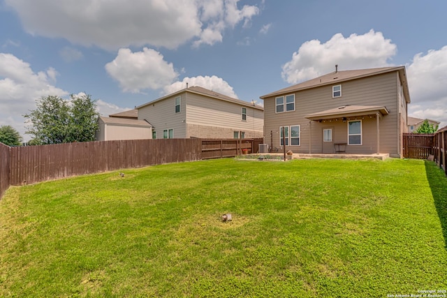 9910 Cowboy Ln, San Antonio, TX 78254 - back of property featuring cooling unit, a patio area, and a vegetable garden