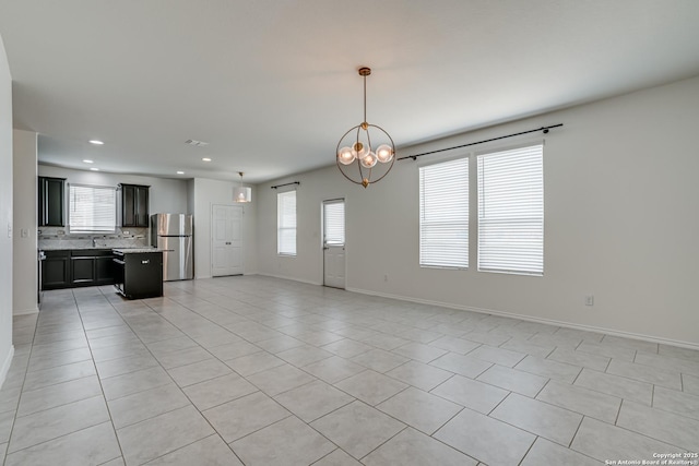 9910 Cowboy Ln, San Antonio, TX 78254 - unfurnished living room featuring healthy amount of natural light, light tile patterned flooring, baseboards, and recessed lighting