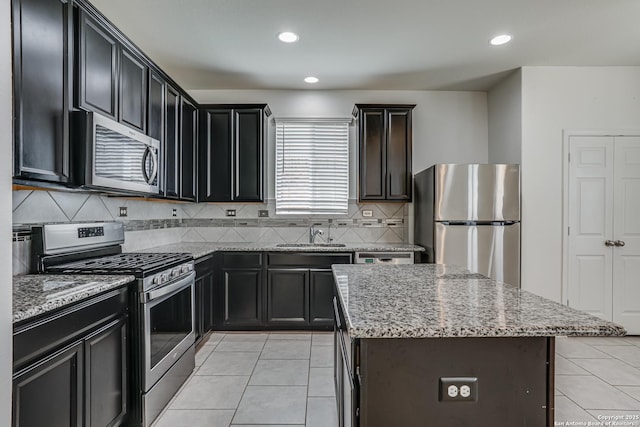 9910 Cowboy Ln, San Antonio, TX 78254 - kitchen featuring stainless steel appliances, a sink, light stone counters, backsplash, and recessed lighting