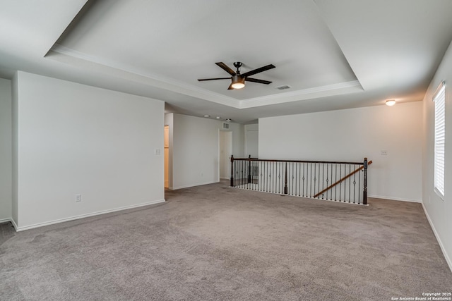 9910 Cowboy Ln, San Antonio, TX 78254 - carpeted spare room with a tray ceiling, a ceiling fan, ornamental molding, and baseboards