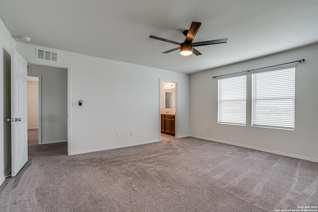 9910 Cowboy Ln, San Antonio, TX 78254 - unfurnished bedroom with light carpet, baseboards, ceiling fan, and ensuite bathroom