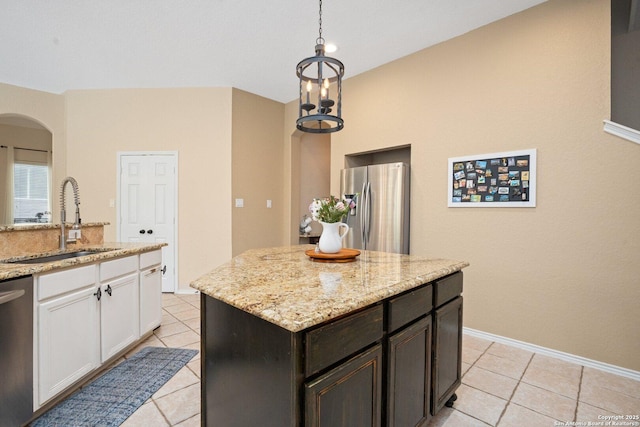 19426 Desert Oak, San Antonio, TX 78258 - kitchen with appliances with stainless steel finishes, light tile patterned floors, arched walkways, white cabinets, and light stone countertops