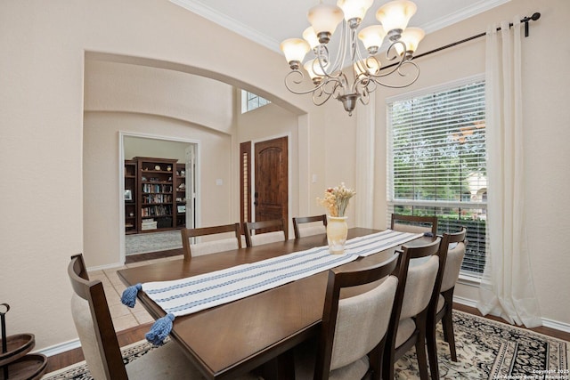 19426 Desert Oak, San Antonio, TX 78258 - dining space featuring a chandelier, arched walkways, ornamental molding, and wood finished floors