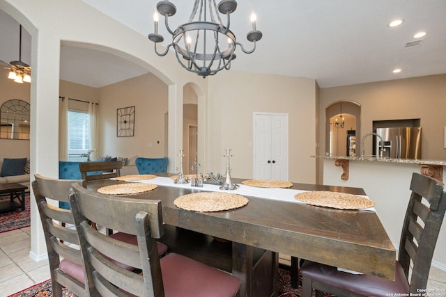 19426 Desert Oak, San Antonio, TX 78258 - dining area with arched walkways, a chandelier, light tile patterned floors, and recessed lighting
