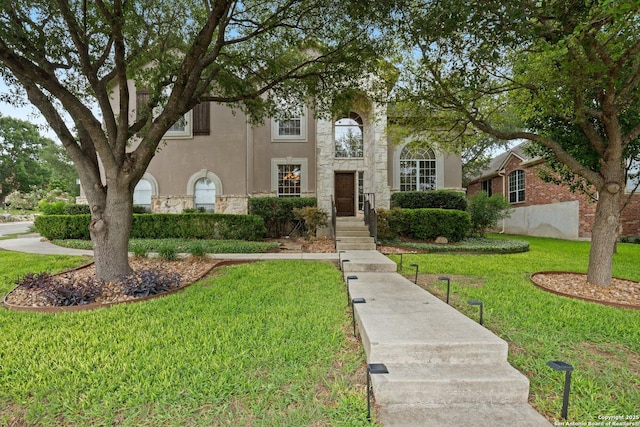 19426 Desert Oak, San Antonio, TX 78258 - view of front of property with a front yard, stone siding, and stucco siding