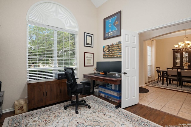 19426 Desert Oak, San Antonio, TX 78258 - home office featuring a chandelier, arched walkways, wood finished floors, and vaulted ceiling