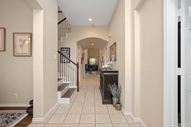 19426 Desert Oak, San Antonio, TX 78258 - foyer entrance featuring arched walkways, stairway, a textured wall, and light tile patterned floors