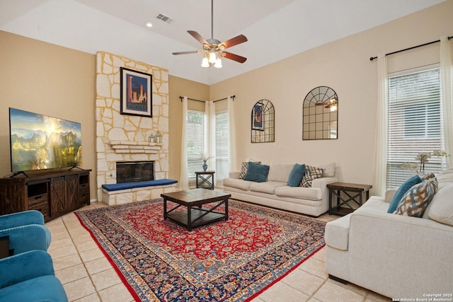 19426 Desert Oak, San Antonio, TX 78258 - living room featuring tile patterned flooring, a ceiling fan, and a stone fireplace