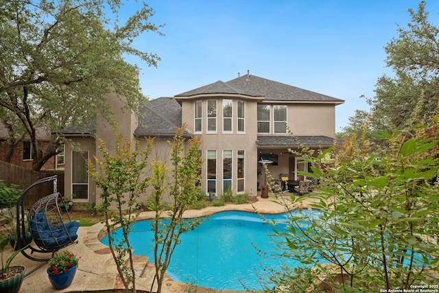 19426 Desert Oak, San Antonio, TX 78258 - rear view of property featuring a patio area, stucco siding, an outdoor pool, and a shingled roof