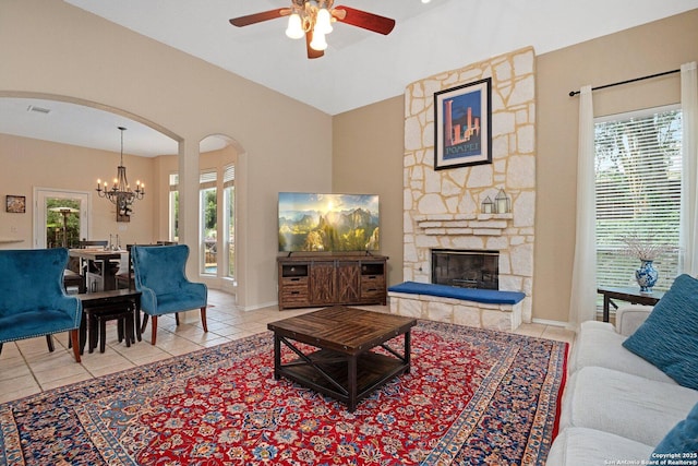 19426 Desert Oak, San Antonio, TX 78258 - living area featuring a ceiling fan, a chandelier, tile patterned floors, arched walkways, and a fireplace