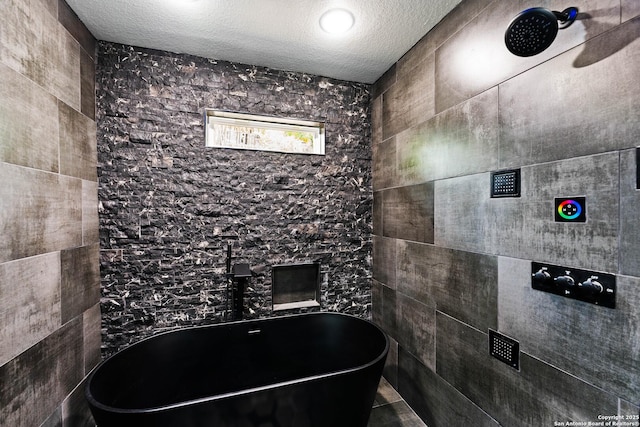 127 Haynes, San Antonio, TX 78210 - bathroom with a soaking tub, a textured ceiling, and tiled shower