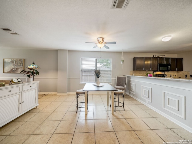 3842 Fiesta Trl, San Antonio, TX 78245 - dining area featuring ceiling fan, light tile patterned floors, and a textured ceiling