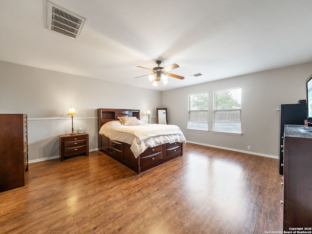 3842 Fiesta Trl, San Antonio, TX 78245 - bedroom with wood finished floors, a ceiling fan, and baseboards