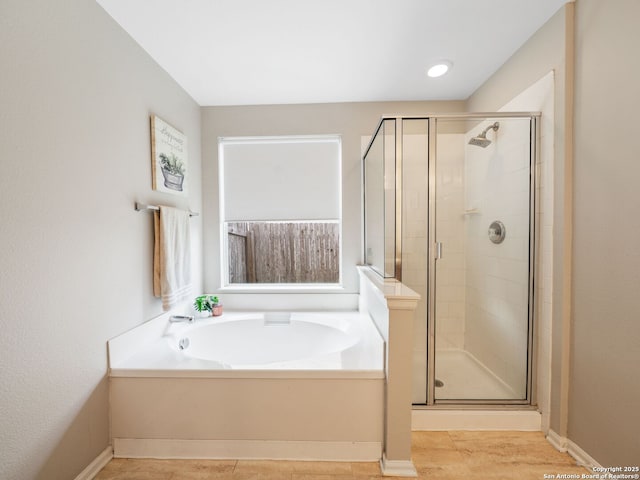 3842 Fiesta Trl, San Antonio, TX 78245 - full bathroom with a bath, a stall shower, and baseboards