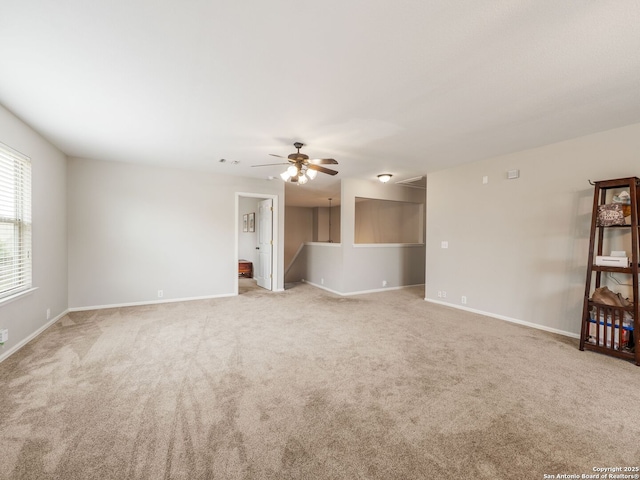 3842 Fiesta Trl, San Antonio, TX 78245 - unfurnished living room with carpet flooring, a ceiling fan, and baseboards
