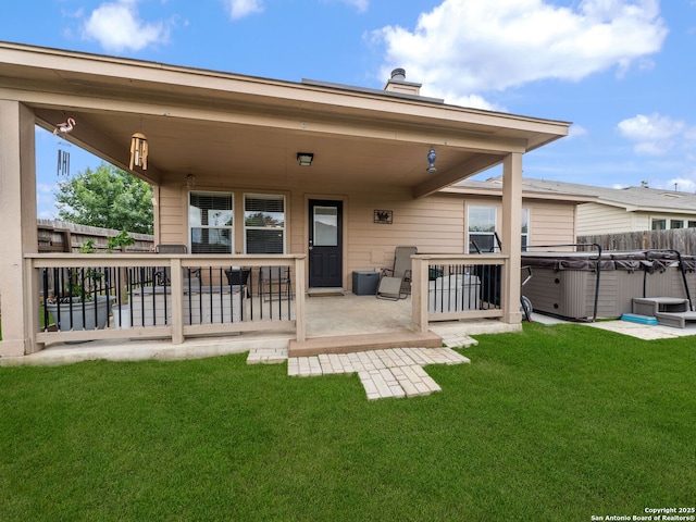 3842 Fiesta Trl, San Antonio, TX 78245 - rear view of property with a hot tub, a patio area, and a chimney