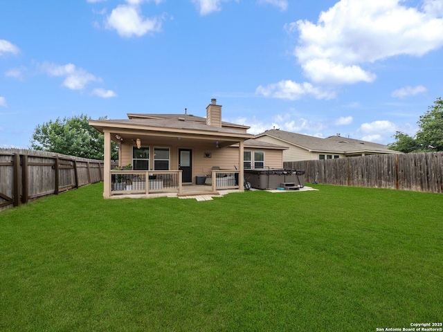 3842 Fiesta Trl, San Antonio, TX 78245 - back of property with a hot tub, a patio, and a chimney