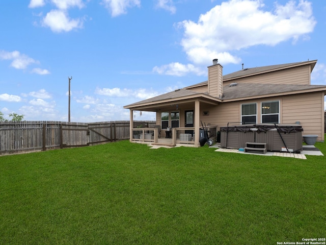 3842 Fiesta Trl, San Antonio, TX 78245 - back of property featuring a hot tub, a patio, a chimney, and roof with shingles