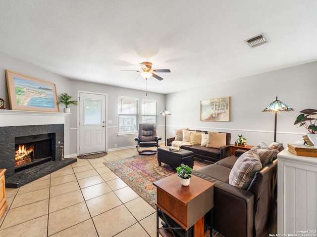 3842 Fiesta Trl, San Antonio, TX 78245 - living room featuring ceiling fan, light tile patterned floors, a premium fireplace, and baseboards