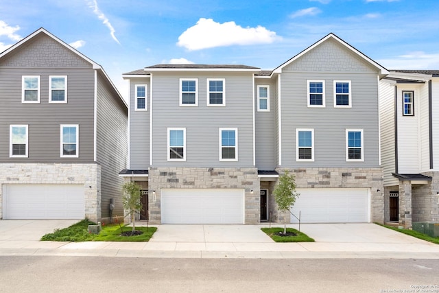 21535 Sir Walter, San Antonio, TX 78256 - view of property with stone siding, a garage, and driveway