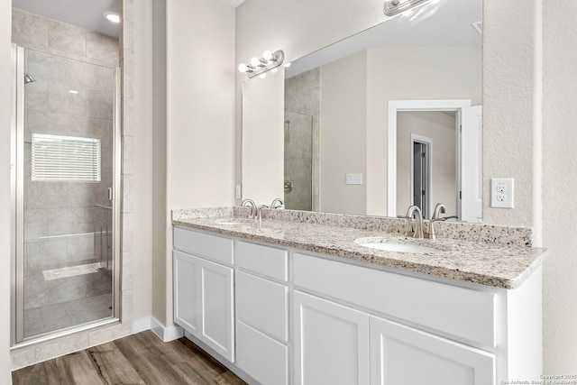 21535 Sir Walter, San Antonio, TX 78256 - bathroom featuring a shower stall, double vanity, and wood finished floors