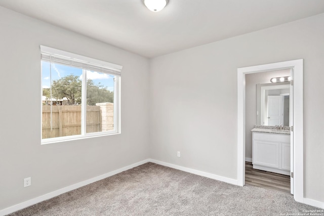 21535 Sir Walter, San Antonio, TX 78256 - unfurnished bedroom with carpet floors, baseboards, and a sink