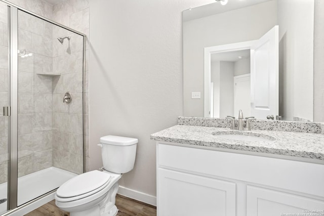 21535 Sir Walter, San Antonio, TX 78256 - bathroom featuring toilet, vanity, a stall shower, wood finished floors, and baseboards