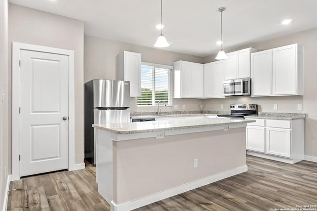 21535 Sir Walter, San Antonio, TX 78256 - kitchen with appliances with stainless steel finishes, a sink, light wood finished floors, white cabinetry, and baseboards