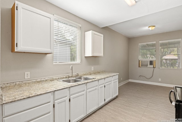 323 Roseborough, San Antonio, TX 78210 - kitchen featuring a sink, plenty of natural light, and white cabinets