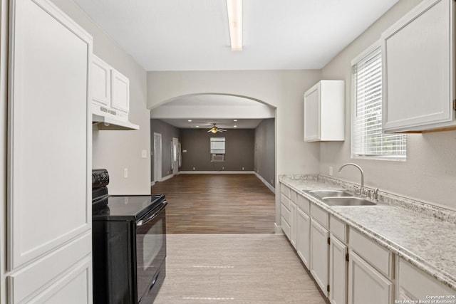 323 Roseborough, San Antonio, TX 78210 - kitchen with electric range, a sink, under cabinet range hood, a ceiling fan, and arched walkways