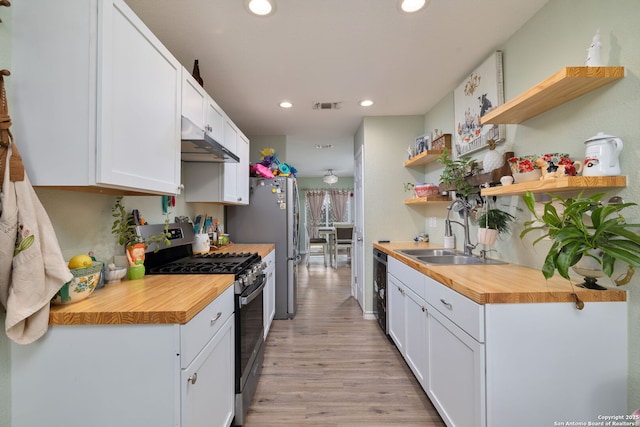 9711 Doefield, San Antonio, TX 78250 - kitchen featuring gas range, open shelves, butcher block counters, under cabinet range hood, and recessed lighting