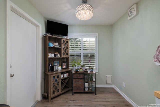9711 Doefield, San Antonio, TX 78250 - home office featuring a chandelier, wood finished floors, and baseboards