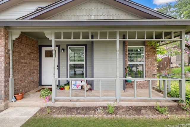 9711 Doefield, San Antonio, TX 78250 - doorway to property with a porch and brick siding