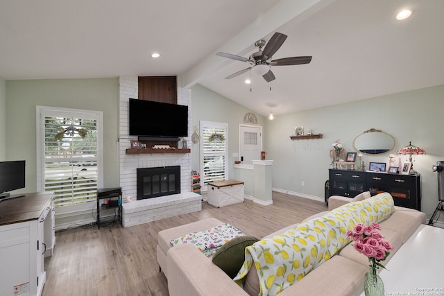 9711 Doefield, San Antonio, TX 78250 - living room featuring a ceiling fan, light wood finished floors, baseboards, and a brick fireplace