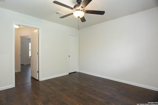 7 Brieley Ln, San Antonio, TX 78250 - spare room featuring dark wood-type flooring, a ceiling fan, and baseboards