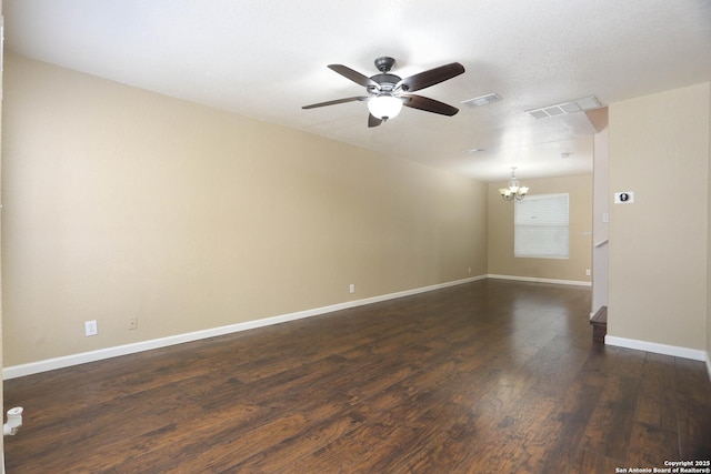 7 Brieley Ln, San Antonio, TX 78250 - unfurnished room featuring a ceiling fan, a chandelier, dark wood finished floors, and baseboards